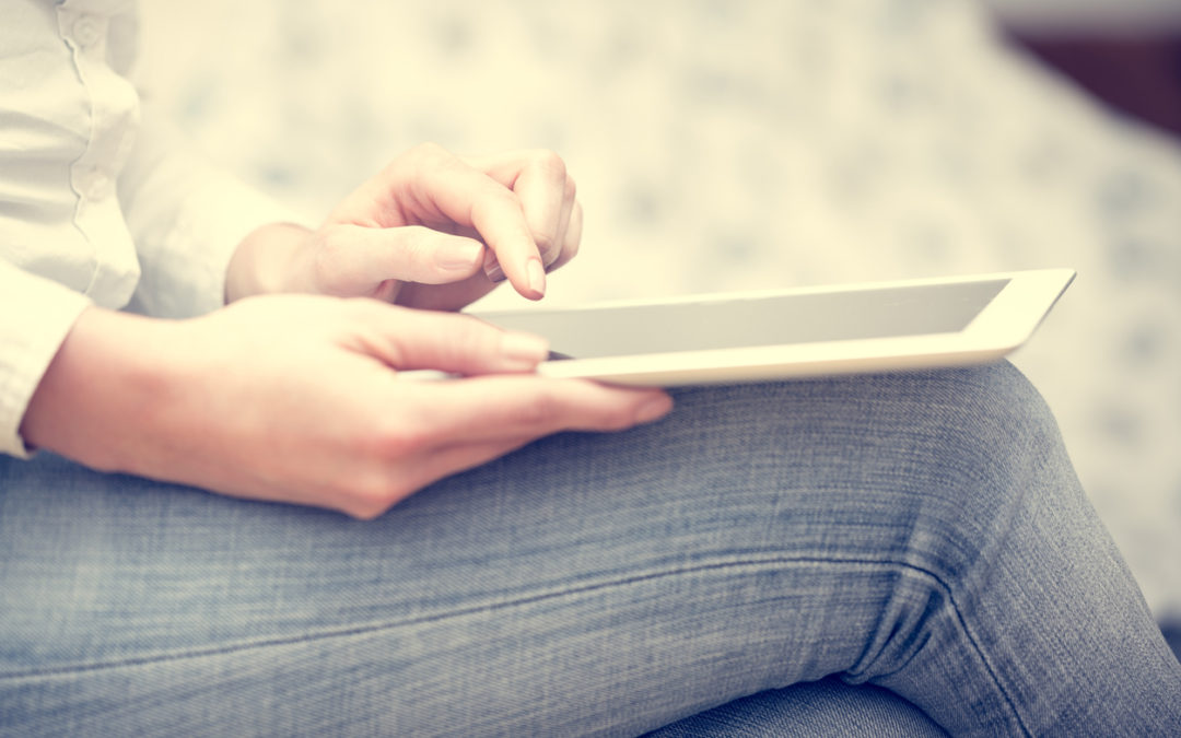digital detox, Woman in jeans pants uses a tablet.