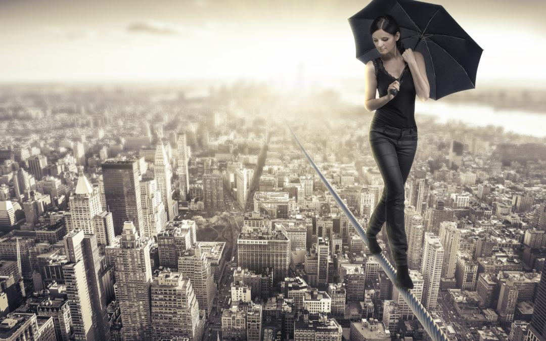 lady on a tight rope walking over a city